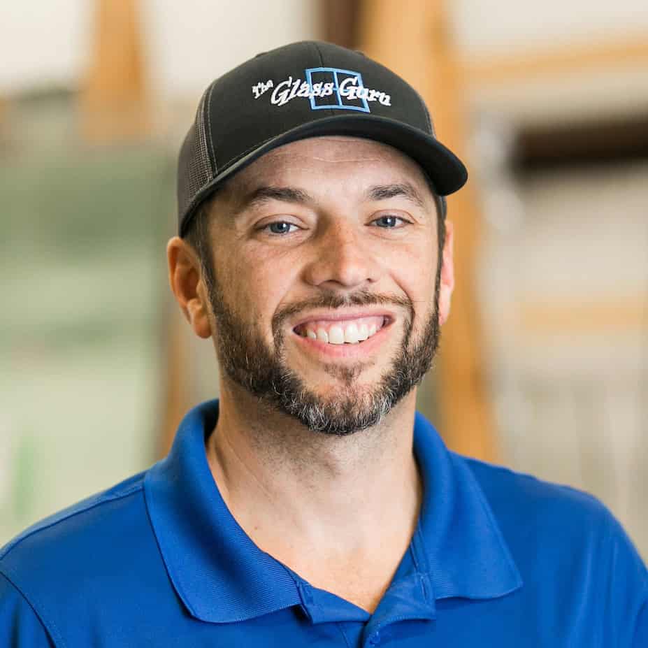 A man wearing a blue shirt and a hat.