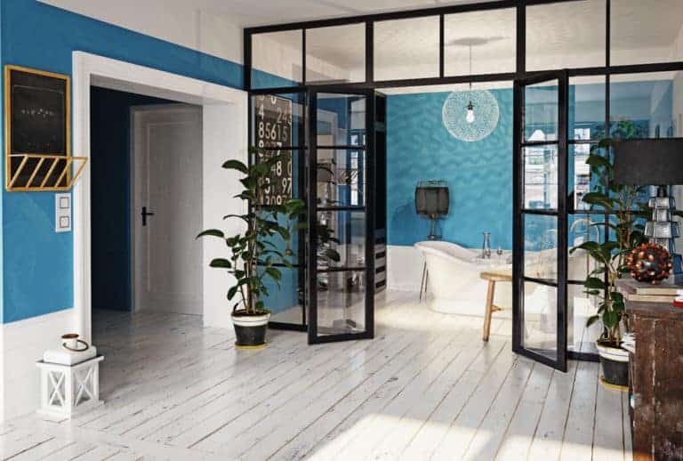 A room with blue walls and wooden floors.