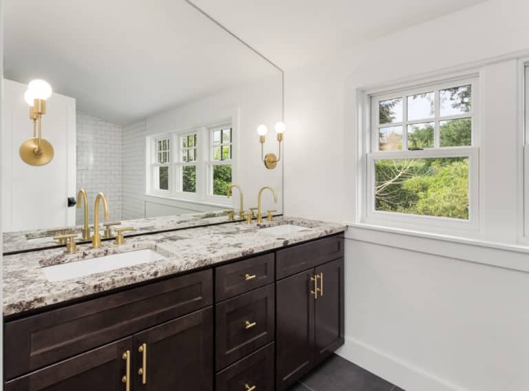 A bathroom with two sinks and a vanity mirror.