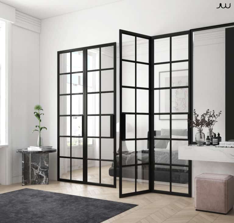 A trendy black and white bedroom with sleek glass doors.