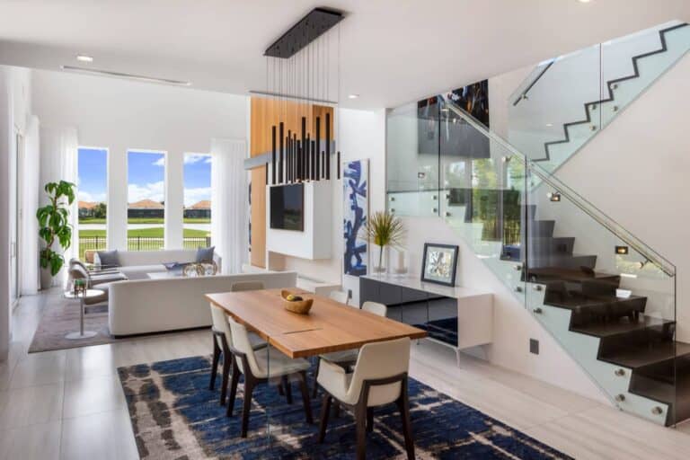 A modern living room featuring a custom glass staircase.